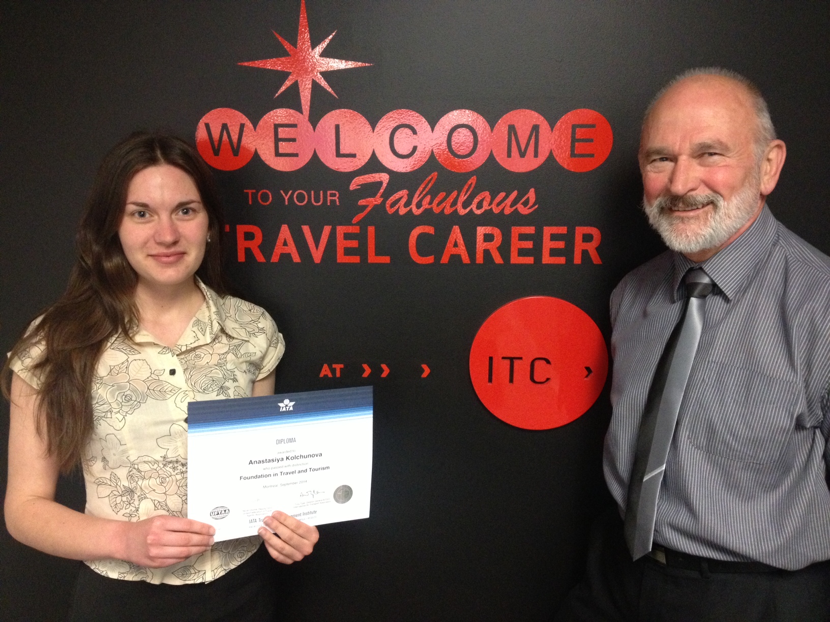 International Travel College student Anastasiya Kolchunova is awarded her IATA Foundation Exam certificate by tutor Steve Burke